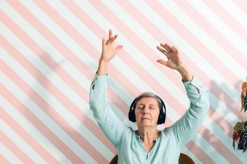 Elderly,Lady,In,Her,Seventies,Listens,To,Music,With,Headphones